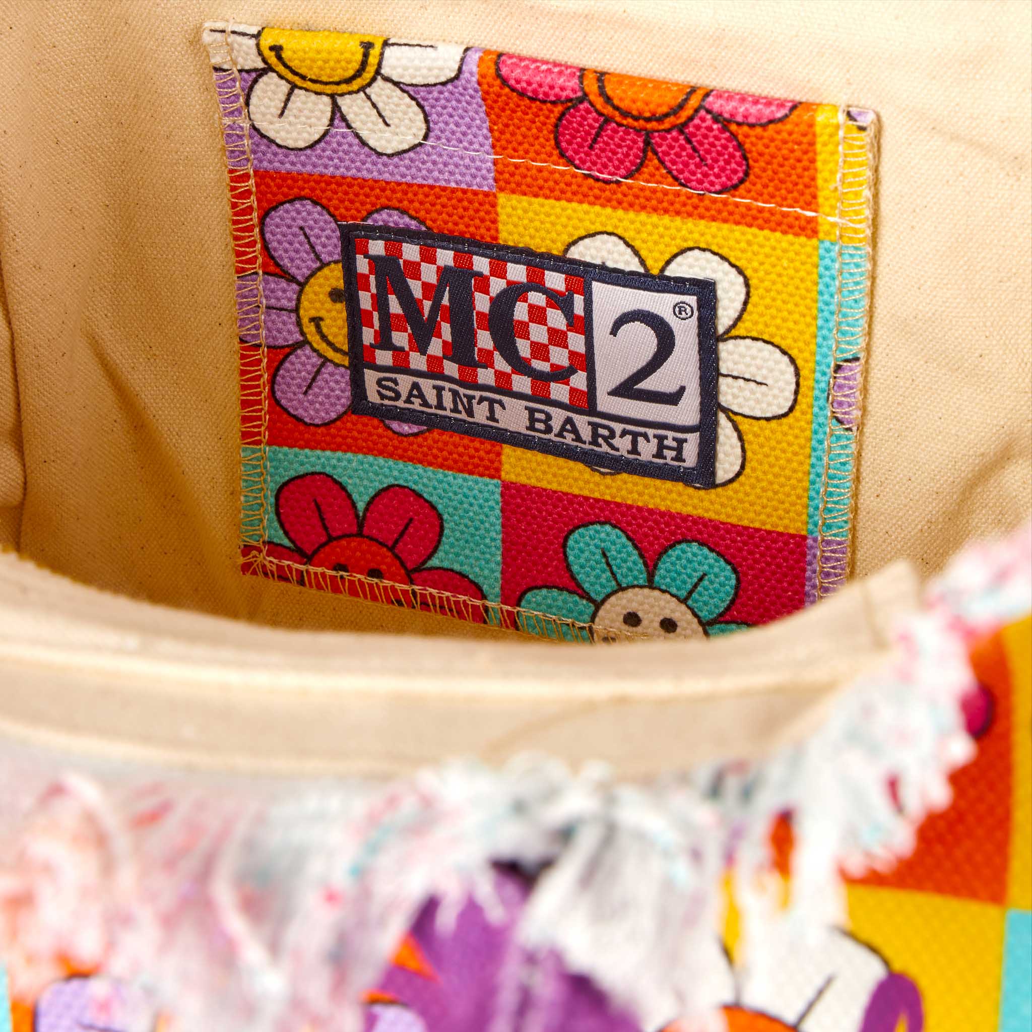Bolso Colette de lona con estampado de margaritas y sonrisa multicolor